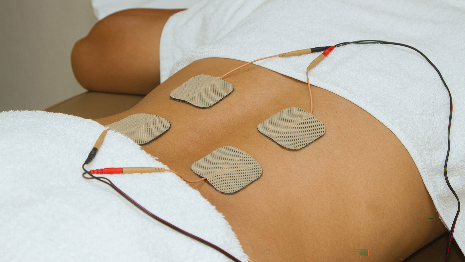Patient Applying Electrical Stimulation Therapy ( Tens ) in back