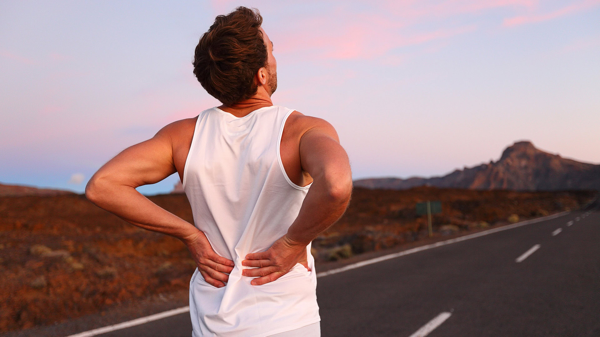 Male runner experiencing lower back pain during exercise