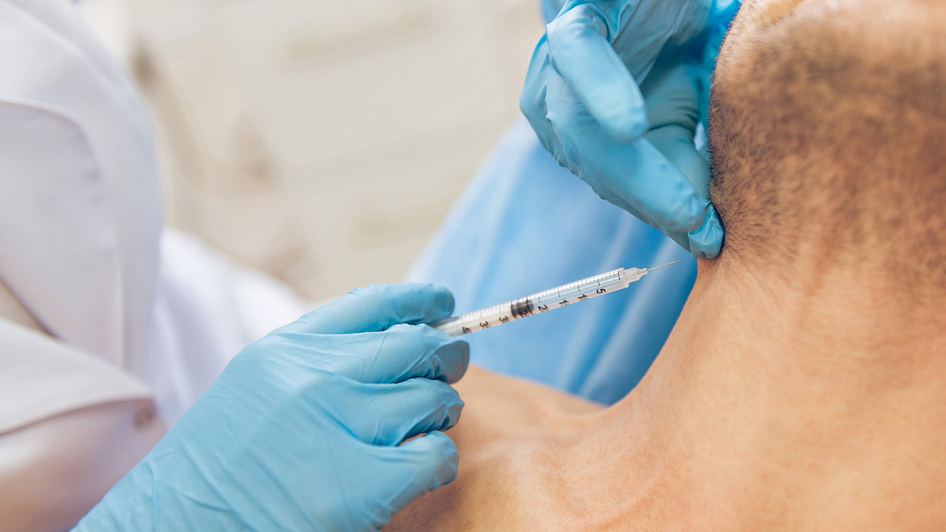 Doctor administering injection to patient's neck